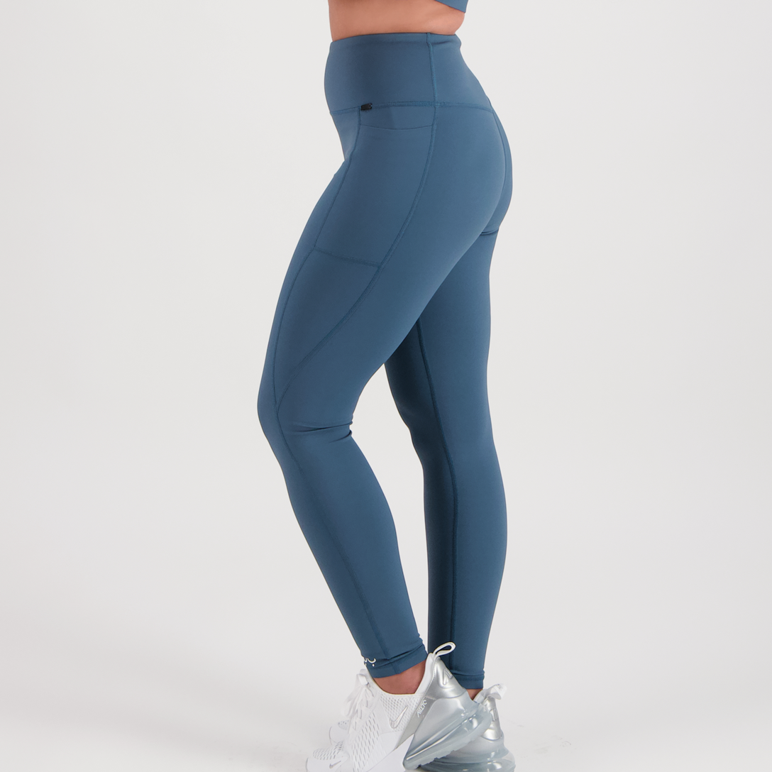 Side View. Model legs in full-length leggings in deep, dusty teal colour