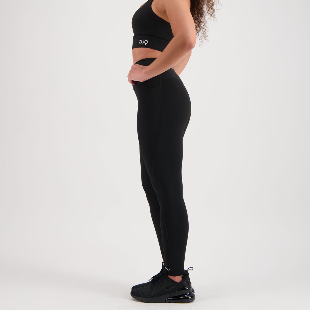View from side. Model legs in full-length leggings in black